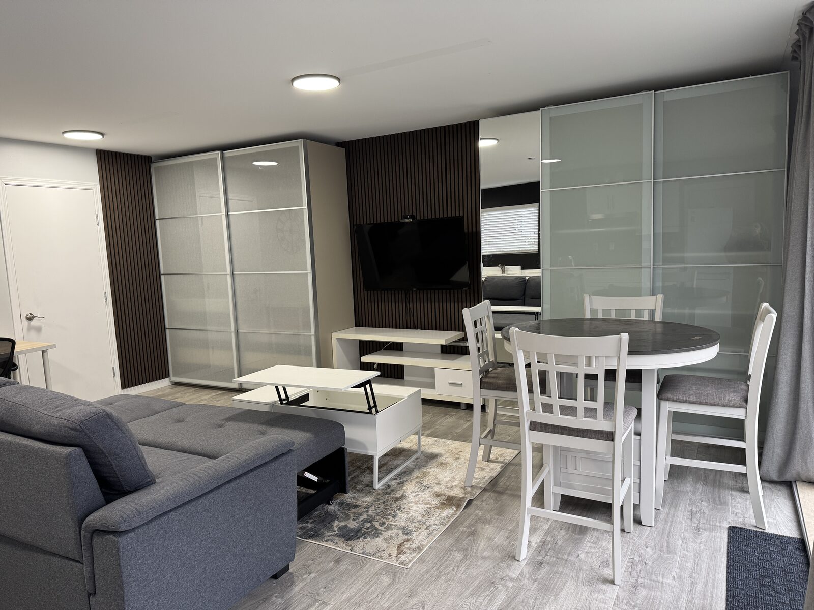 Living area with mounted TV and media wall